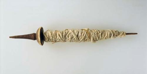 Distaff with spindle whorl and fiber