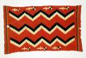 Serape, vertical layout. Wool: red background, three vertical stepped zigzags