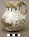 Ceramic pitcher, handle, black on white, flared rim with sherds missing