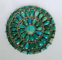 Pin, round silver base set with 52 turquoise stones in 3 rows around a center st