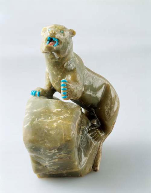 Effigy of a mountain lion on a rock, serpentine with turquoise eyes, teeth & cla