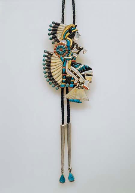 Bolo, Indian dancer wearing feathered costume, inlaid with diff. materials