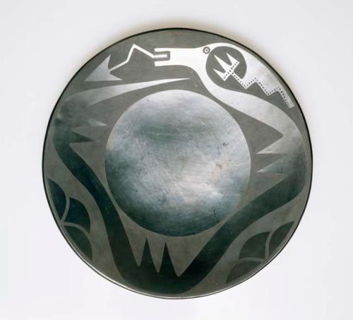 Black-on-black plate with avanyu motif