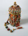 Basketry container with lid - covered with red cotton cloth, cowrie shells and b