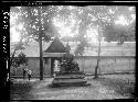 Large seated statue in front of building