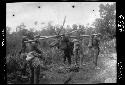 Men carry animal head on sticks