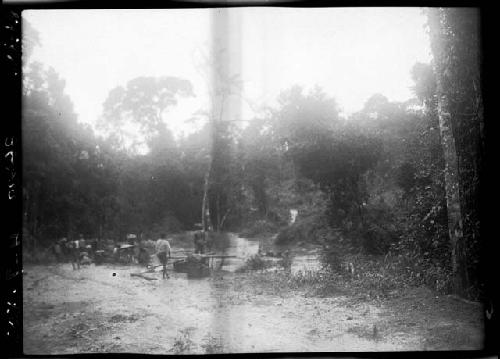 People gather along river