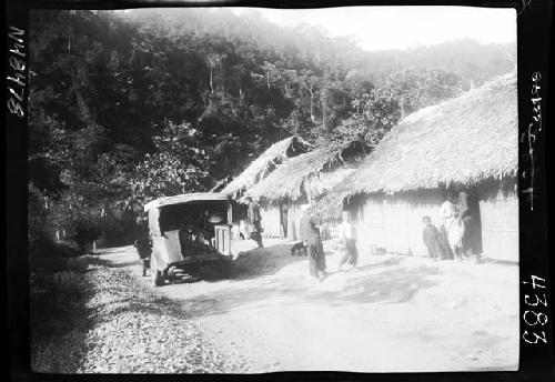 Truck moves past homes