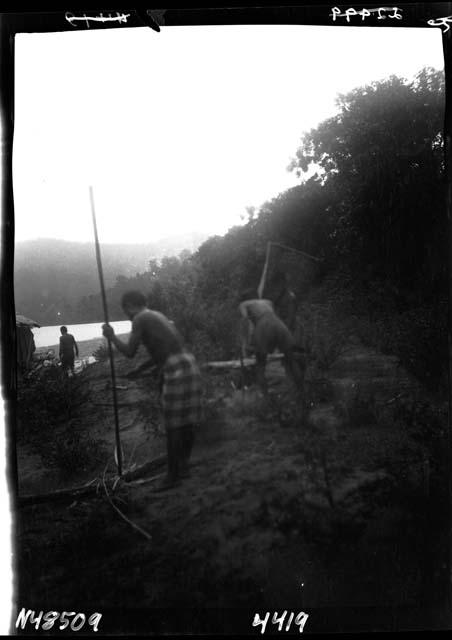 People working along riverbank