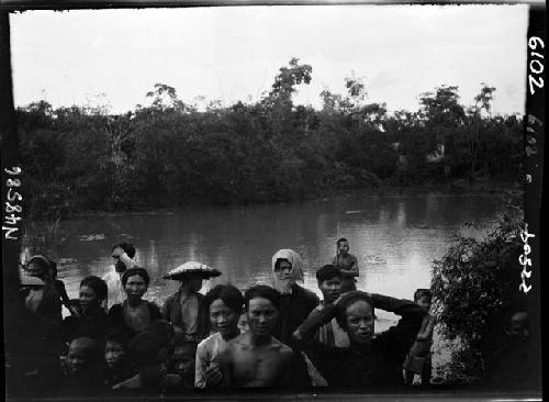 People lined up along river