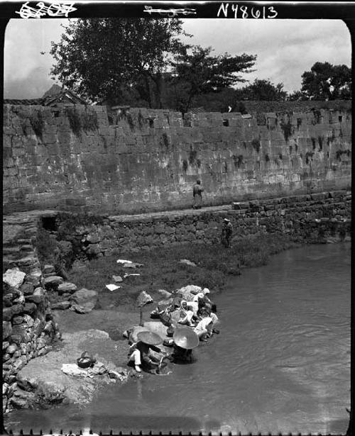 City wall, people getting water