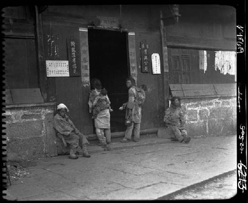 People sitting/standing outside building