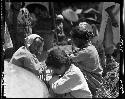 Women and children seated outside