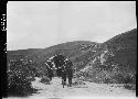 Man and wagon traveling on road