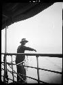 Person standing on deck of boat