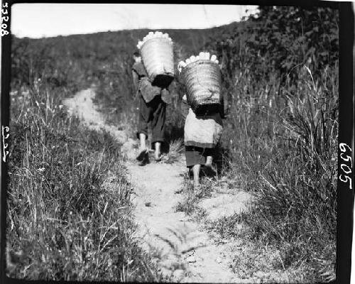 People carrying loads on backs