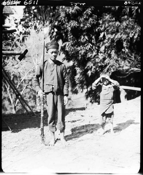 Two children standing outside