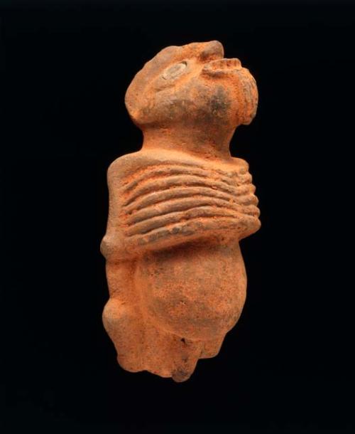 Human male figure in soft stone, painted red