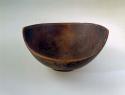 Bowl, carved wood, flared sides, rim peaked at opposite ends, abraded