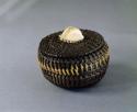 Coiled baleen basket; carved ivory handle represents walrus head