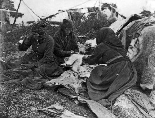 Women pounding skins
