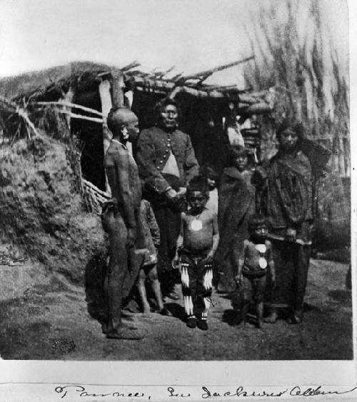 Pawnee group standing at door of lodge