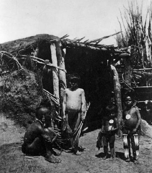 Pawnee group standing at door of lodge