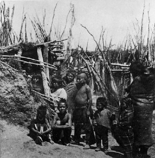 A group standing beside a lodge