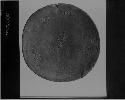 Wooden disk: human figures incised in convex side, inlaid with sheet, turqouise and glass beads. Interior decorated with incised fish.