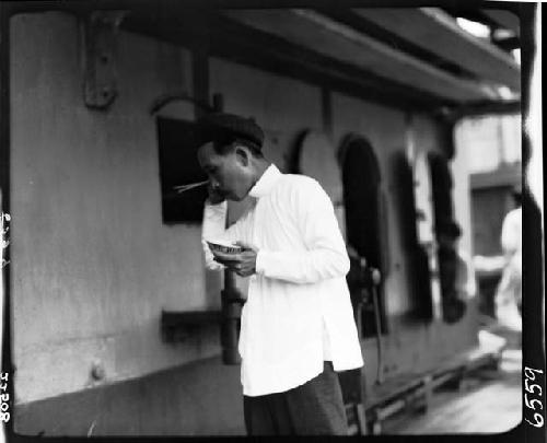 Man holding bowl and chopsticks