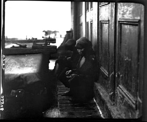 Woman crouching next to table