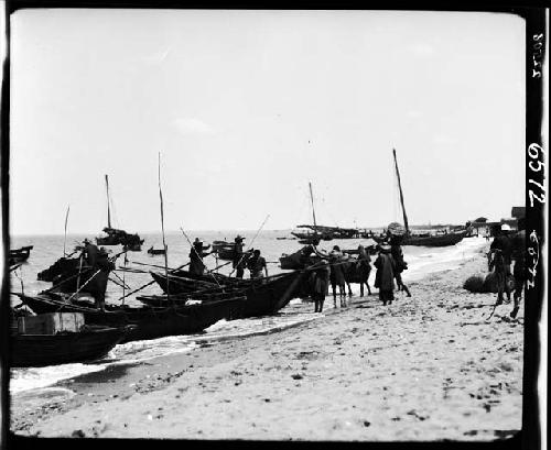 Boats and people on shore