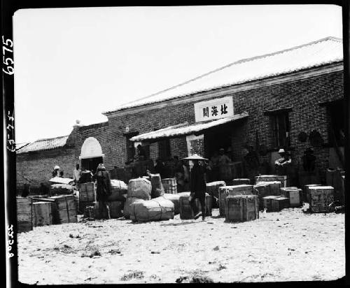 People and boxes outside building