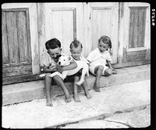 Children playing with dog