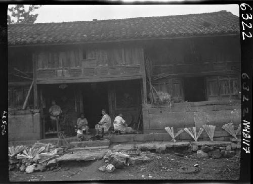 People sitting on building's porch