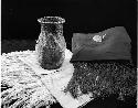 Collection of Ernestine Begay. Water basket, shawl, textiles, saddlebag.