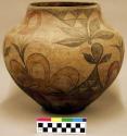 Pottery olla. Cream slip with brown, yellow and red designs