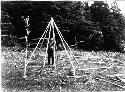 Person standing in wigwam frame