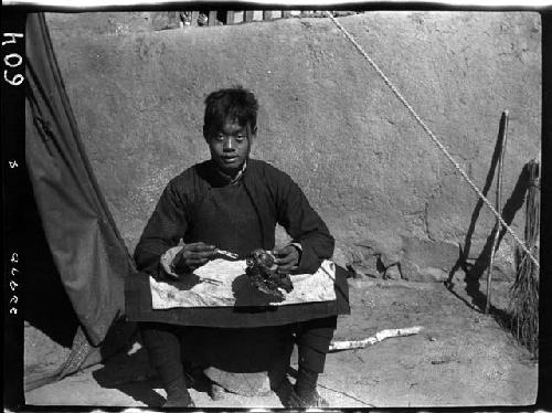 Person sitting outside tent