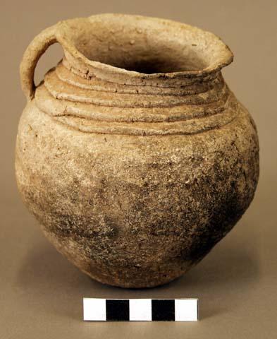 Jar, small handle, coiled at neck, water-worn or abraded surface