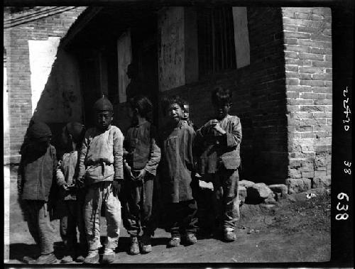 Children lined up outside building