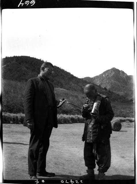 Two men standing outside