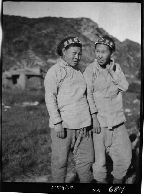 Two women standing outside