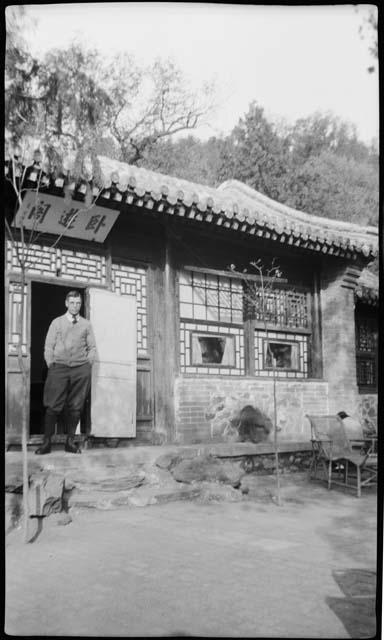 Man stands in doorway of building