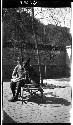 Man sitting on bench on patio, with dog sitting on bench