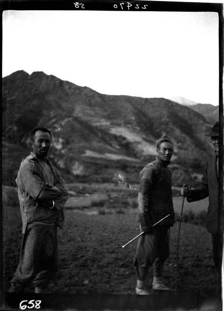 Two men standing outside