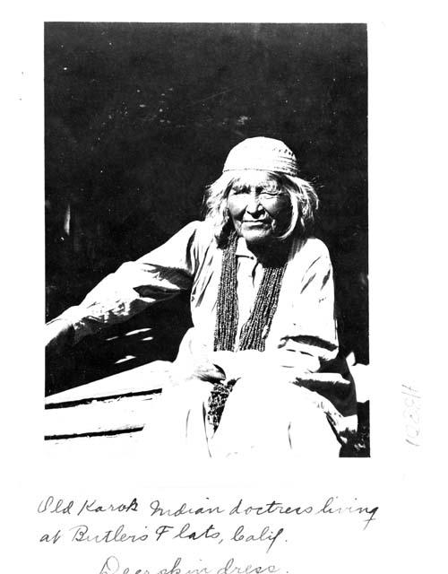 Old Karok Indian doctress living at Butler's Flats, California. Deerskin dress