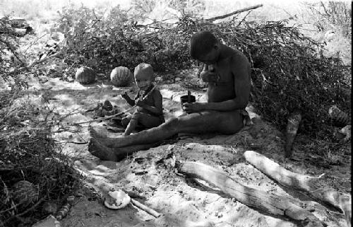 !Gai rubbing fat on his chest and Oukwane playing with a bow