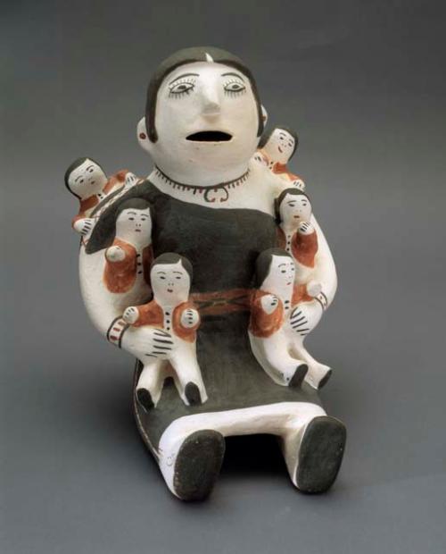 Polychrome-on-white seated female storyteller