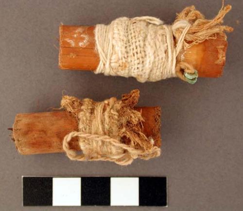 Wood, cane cigarettes, both wrapped in cotton and fiber, one with turquoise bead